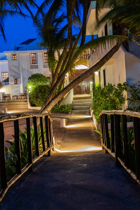 Casa del Secreto's lantern-lit entrance path and stairs at dusk