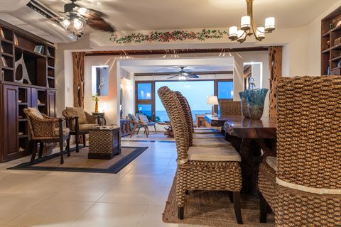 Casa del Secreto's living and dining room opening to an ocean-view window