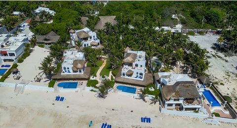 Aerial view of Hacienda del Secreto's beachfront villas and pools on Playa del Secreto
