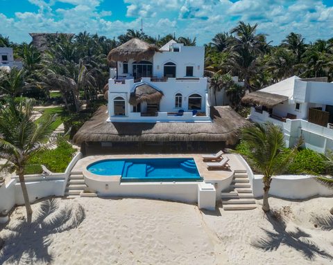 Aerial view of Hacienda del Secreto's beachfront villas and pools on Playa del Secreto
