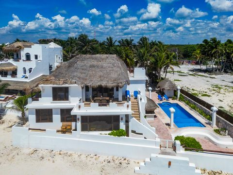 Aerial view of Hacienda del Secreto's beachfront villas and pools on Playa del Secreto