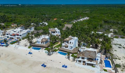 Aerial view of Hacienda del Secreto's beachfront villas and pools on Playa del Secreto