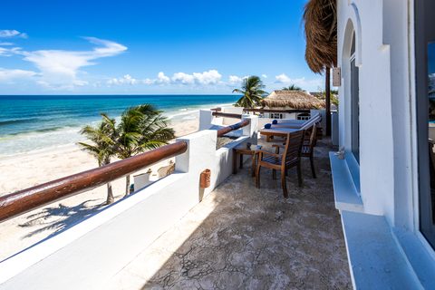 Villa Sarita at Hacienda del Secreto, a turquoise-and-gold beachfront villa on Playa del Secreto