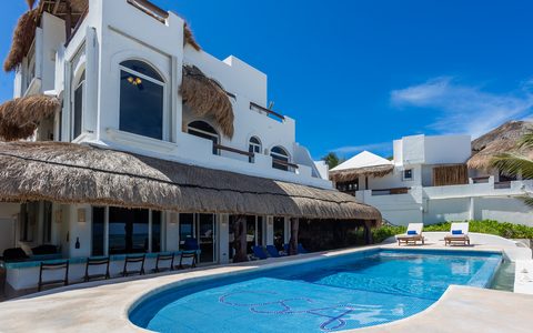 Villa Sarita’s pool terrace and whitewashed levels under a bright sky